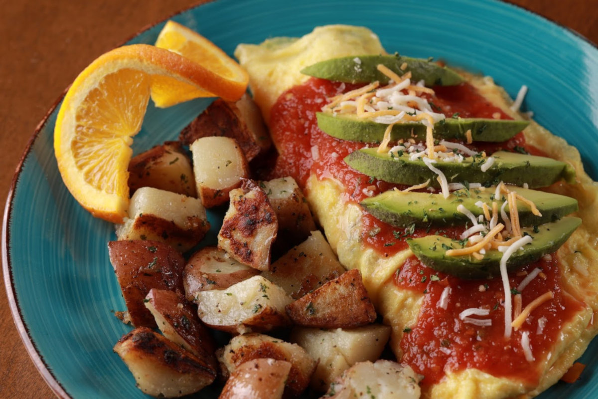 Omelette with sauce potatoes and various decorations